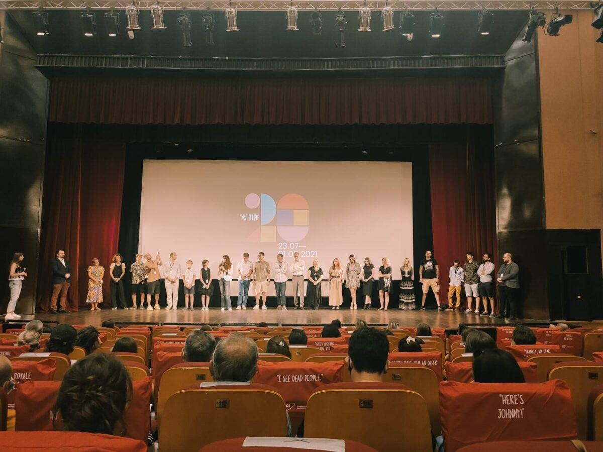 The film crew lined up on a cinema stage in front of the audience, at TIFF 2021