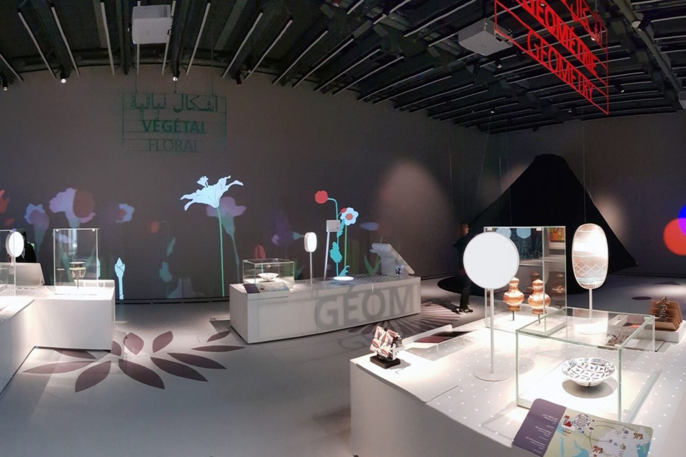 Low display cases and projections in the Travelling Shapes and Colours exhibition